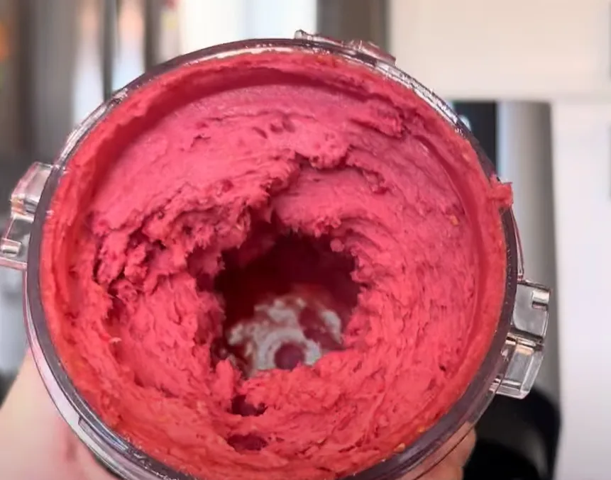 Pink keto dessert in a food processor bowl.