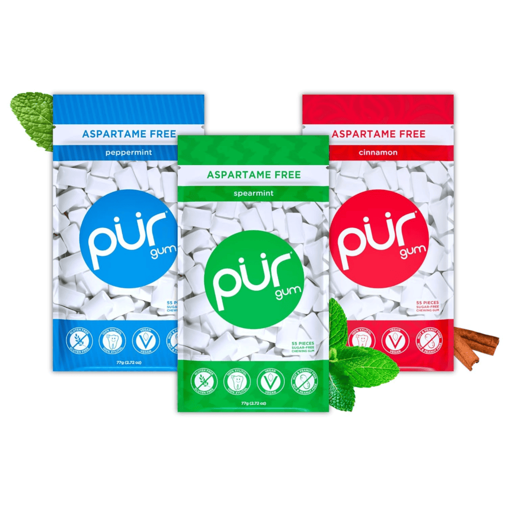 Three bags of Pur gum, aspartame-free and made with xylitol, in peppermint, spearmint, and cinnamon flavors.